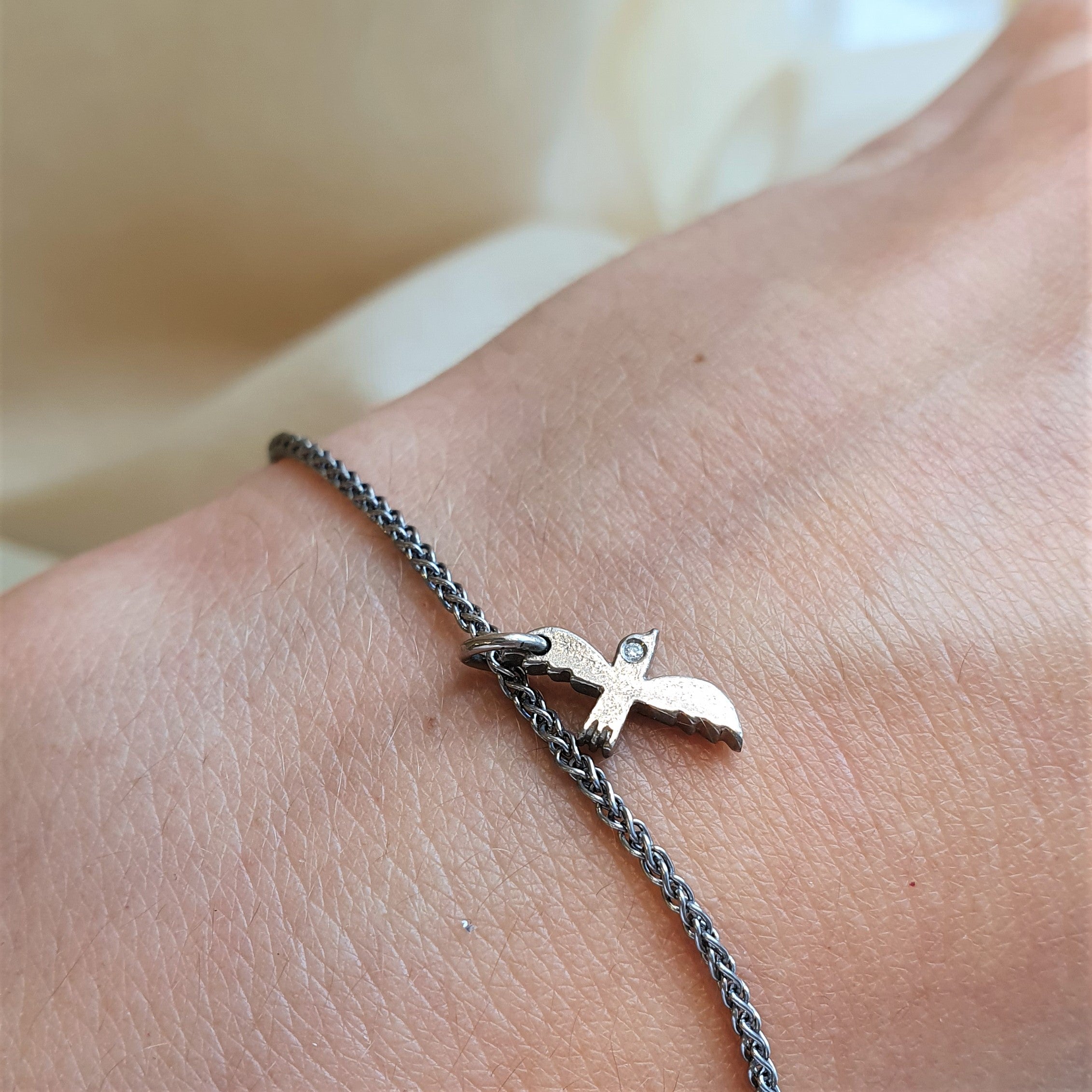 Bracelet with gold bird, white gold